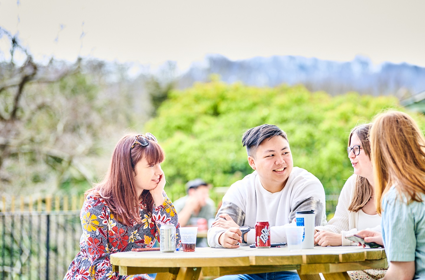 4 students chatting outside