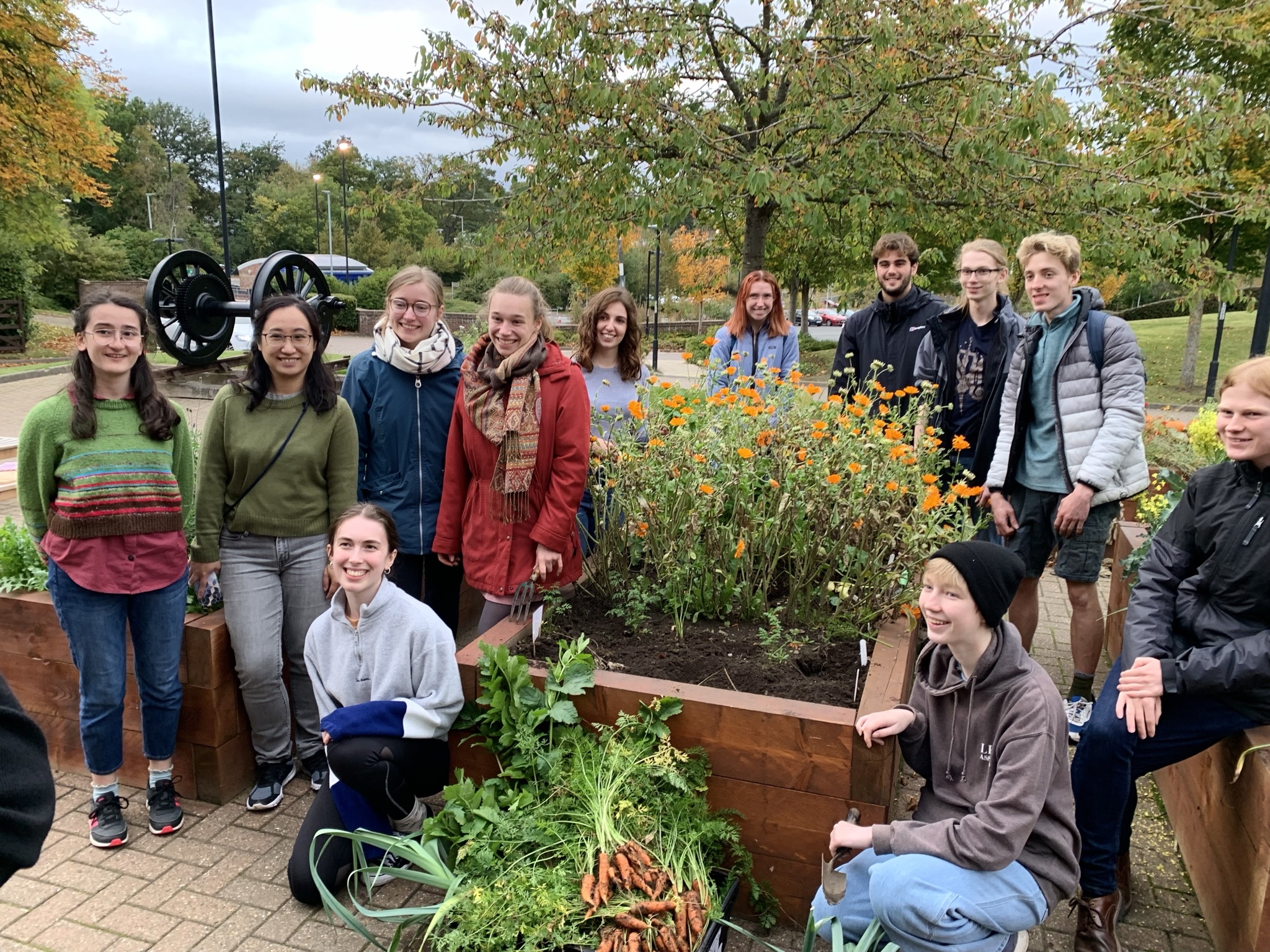 A group of students in front of a vegetable harvest