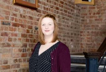 Helen standing in front of stairs