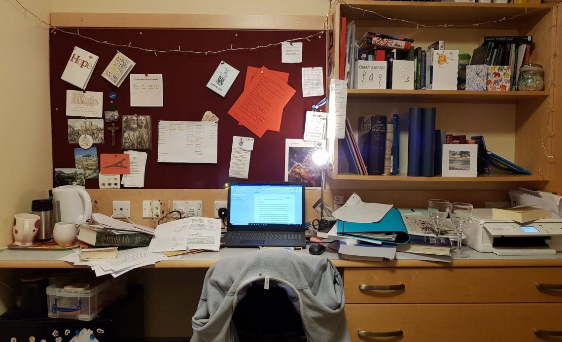 Students personal desk space covered in books and notes.