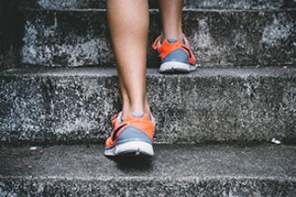 Person's feet in trainers running up steps