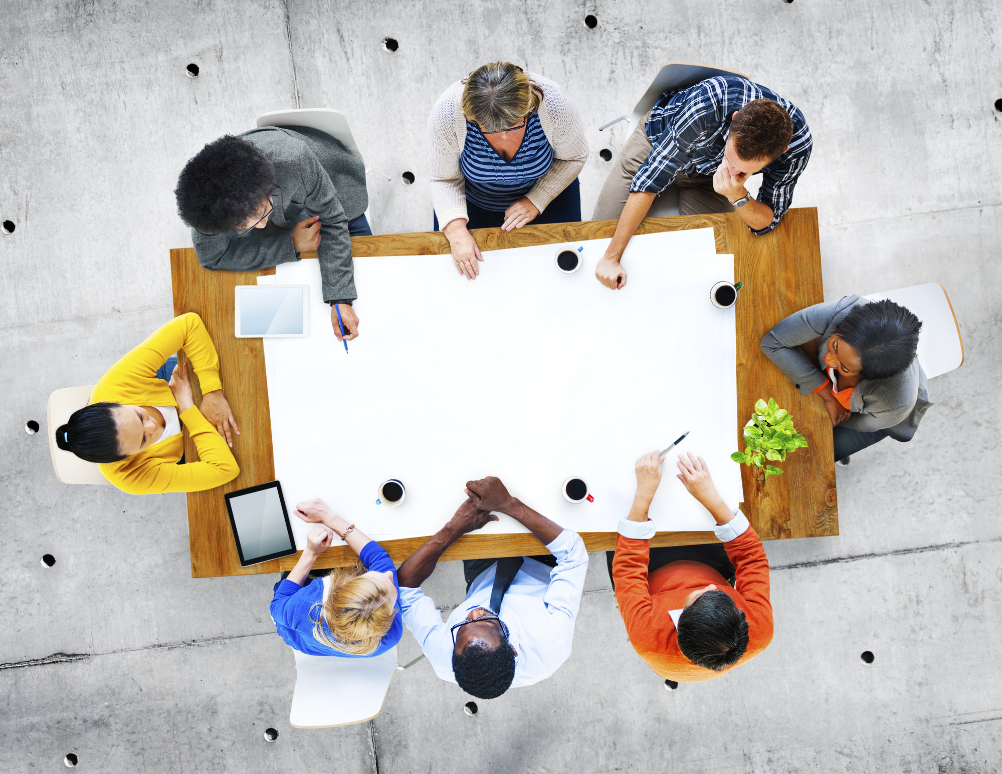 group of researchers sitting around a table in discussion