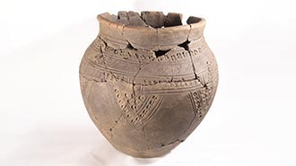 Reconstruction of a prehistoric pot with decoration comprising dots and lines