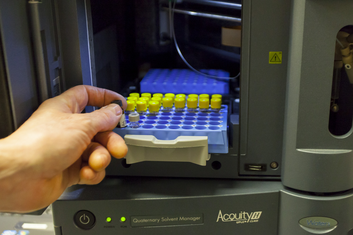 person loading samples in chromatography instrument