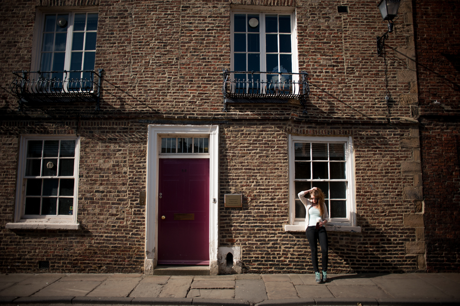 Student standing outside department building.