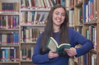 student holding book