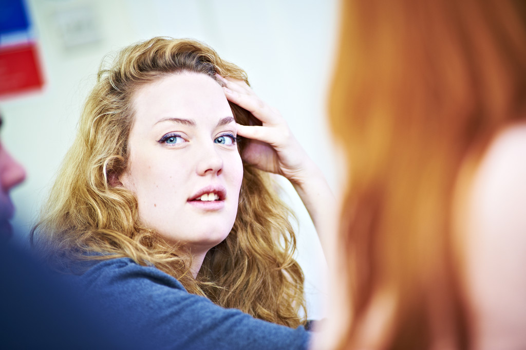 A close up of a womans face in a seminar