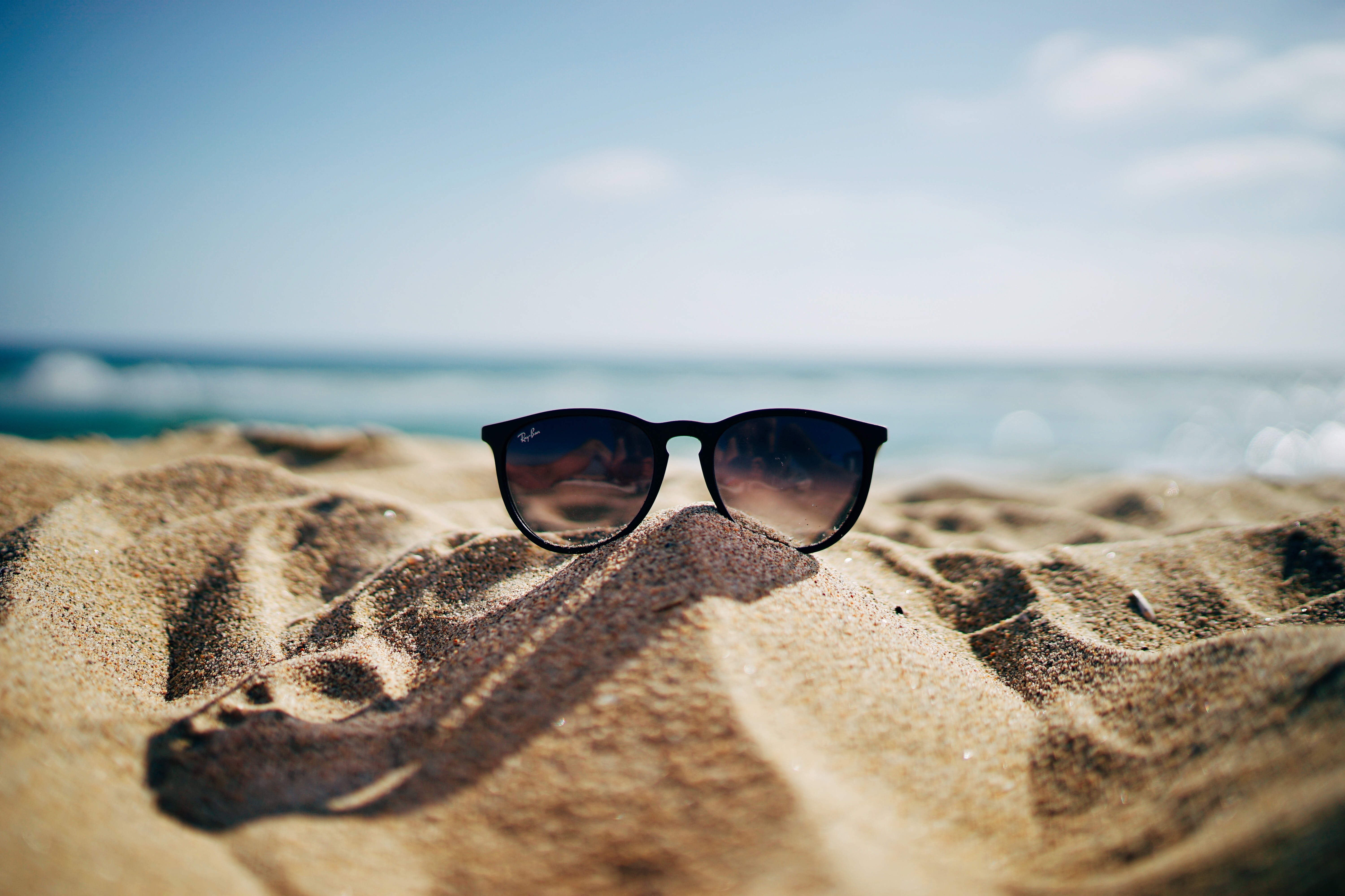 A sand pile with sunglasses atop