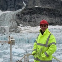 Colm stood near some icy water