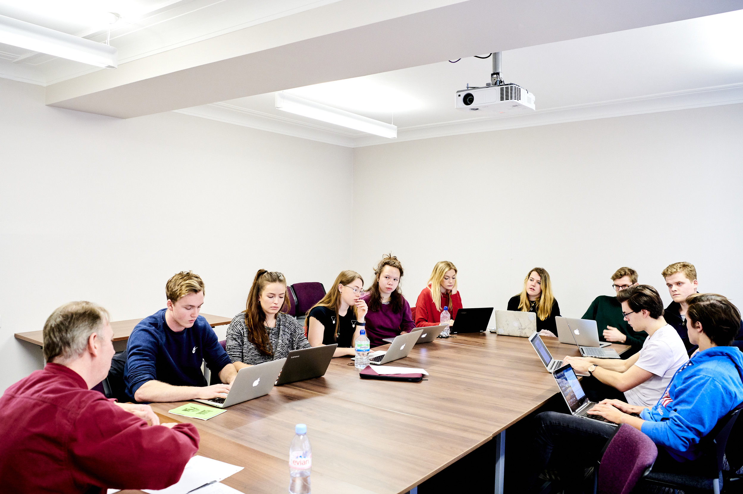 Students sat round a table with laptops