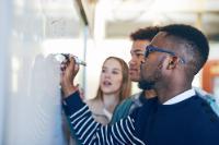 students writing on board