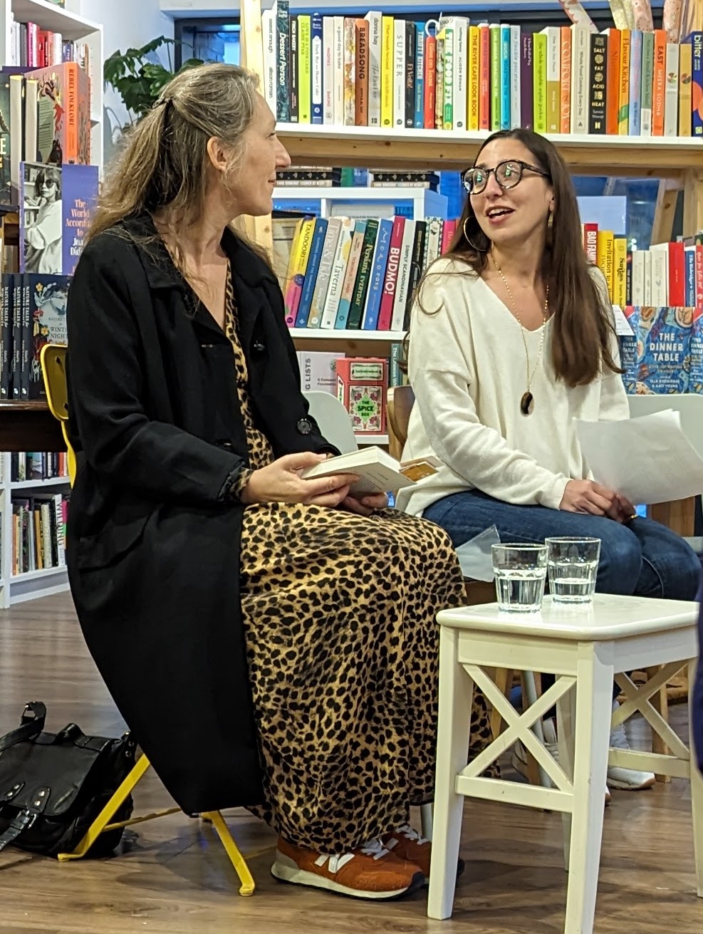 Two females sitting down in a book shop