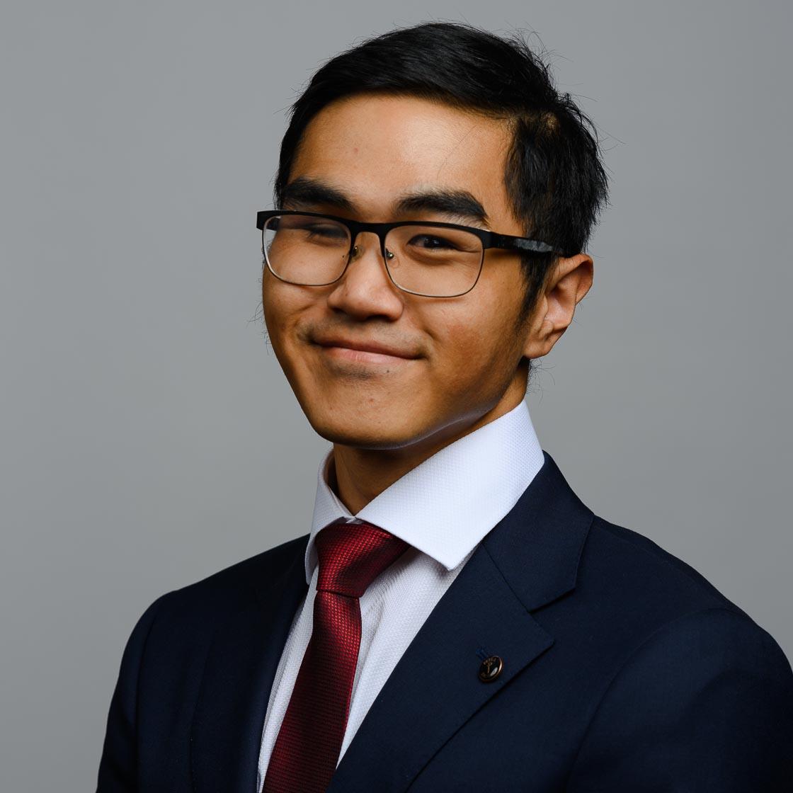 A headshot of a man in a suit