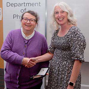 Photograph of Carolyn receiving his award, presented by Paula Chadwick