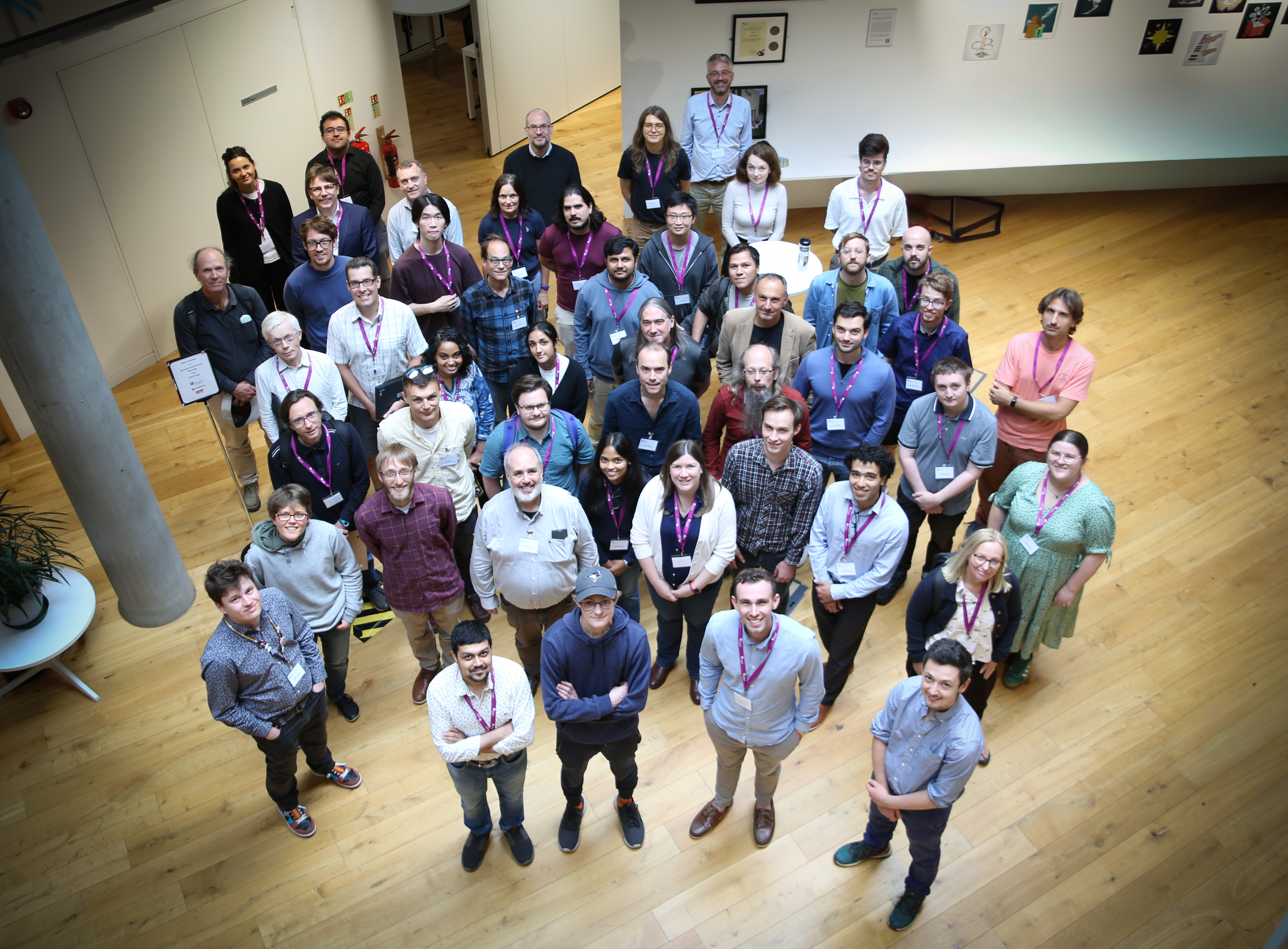 Group photo of attendees of the New Frontiers in Quantum-Emhanced Sensing international workshop looking up at camera