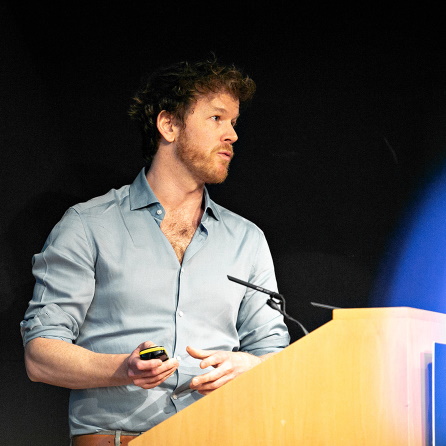 Photo of Professor Duncan Astle speaking from a lecturn.