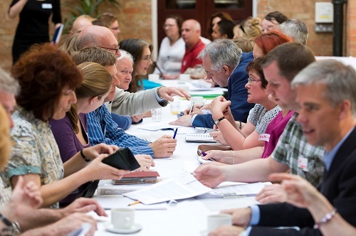 Group of researchers networking across a table