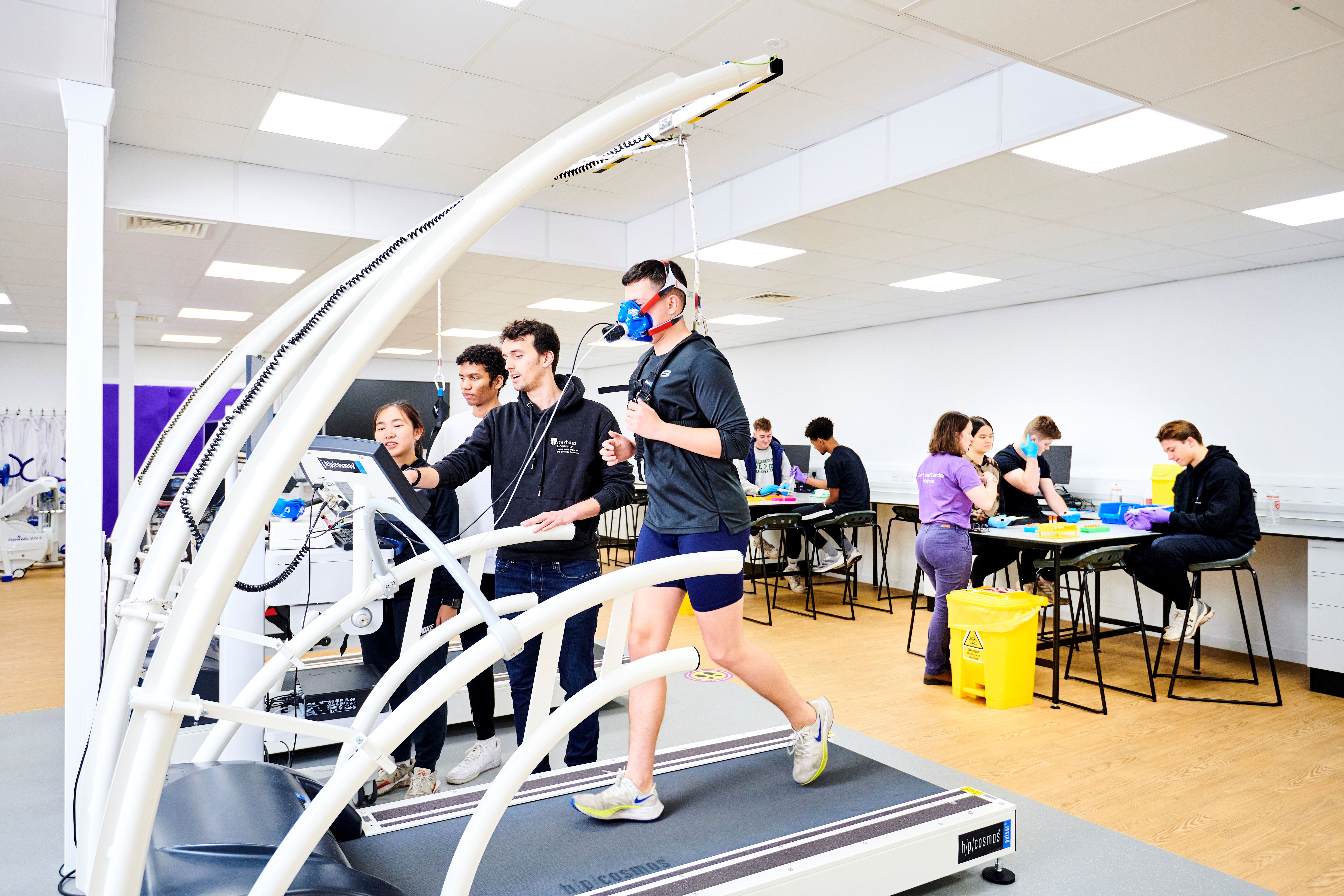 Groups of students and staff members participating in lab practicals in human performance lab