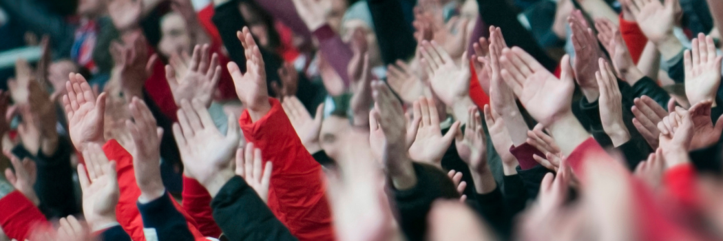 Crowds of people hands in air