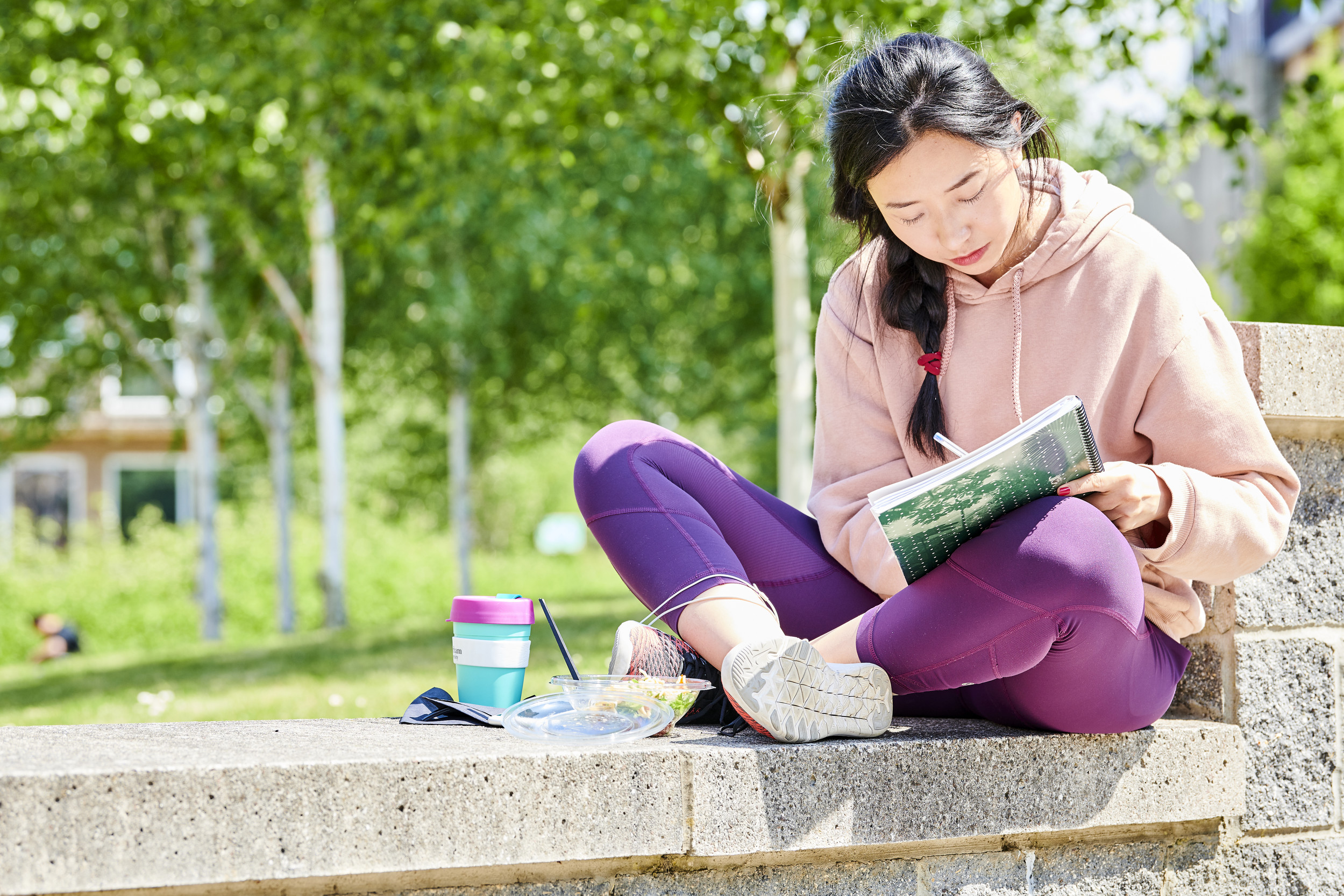 Student sat studying on campus