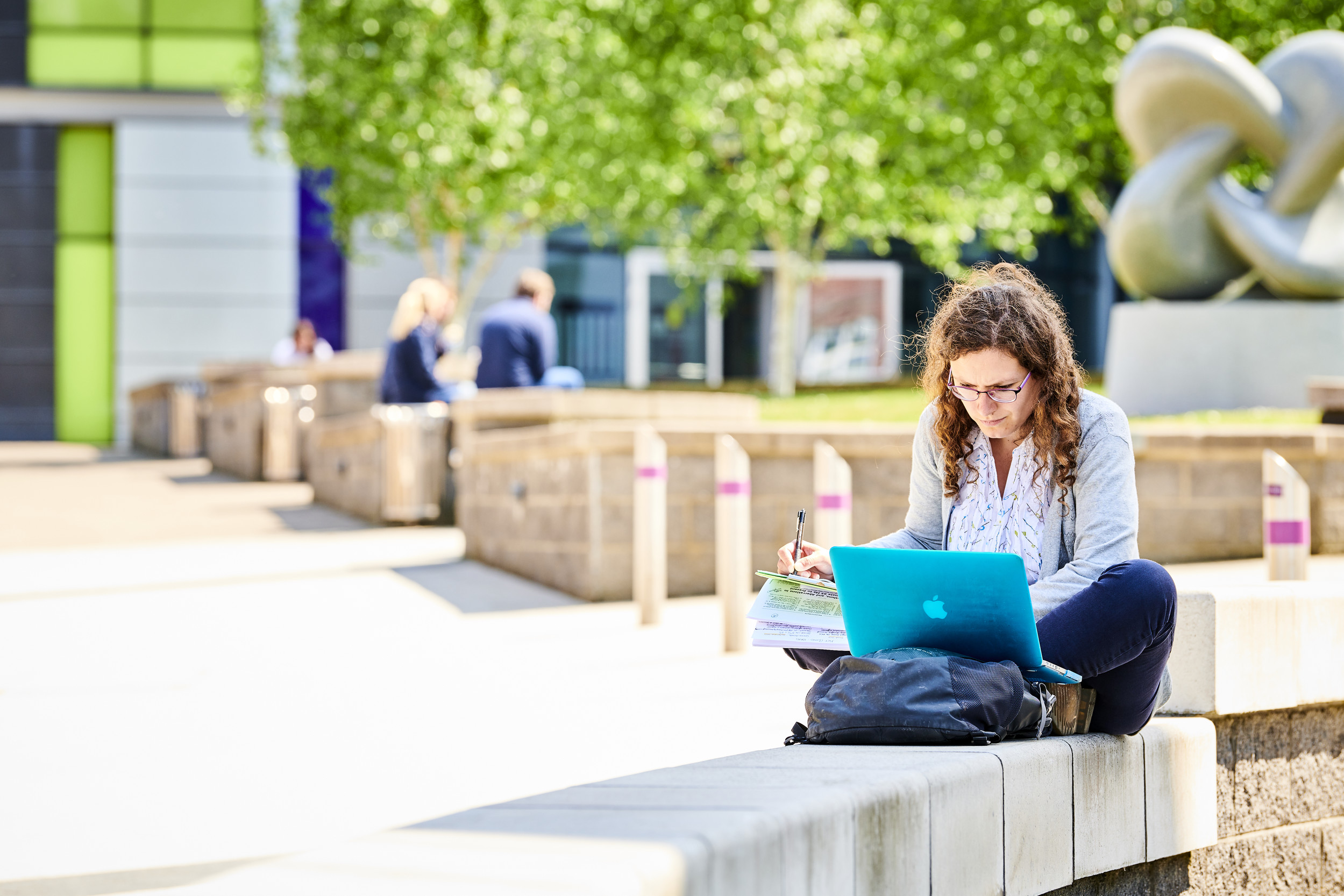 Student sat studying on campus