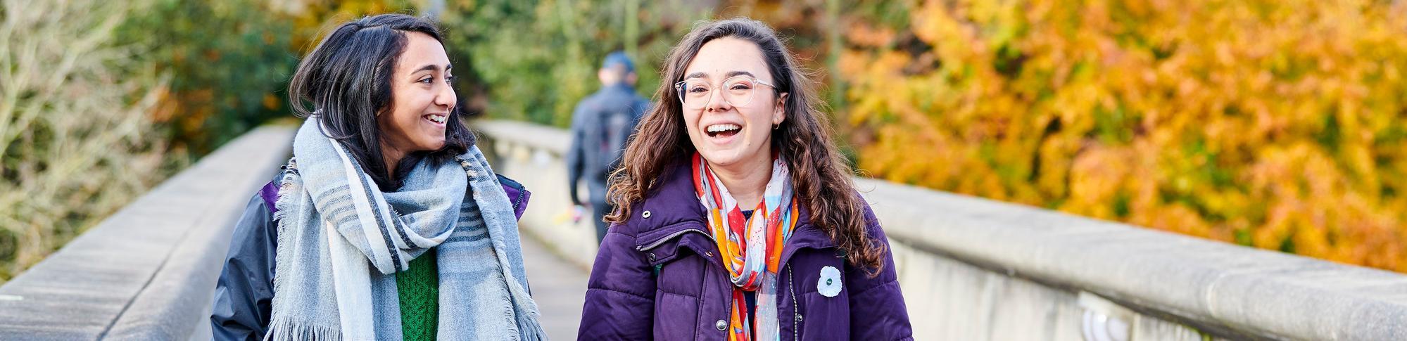 Two students crossing Kingsgate Bridge