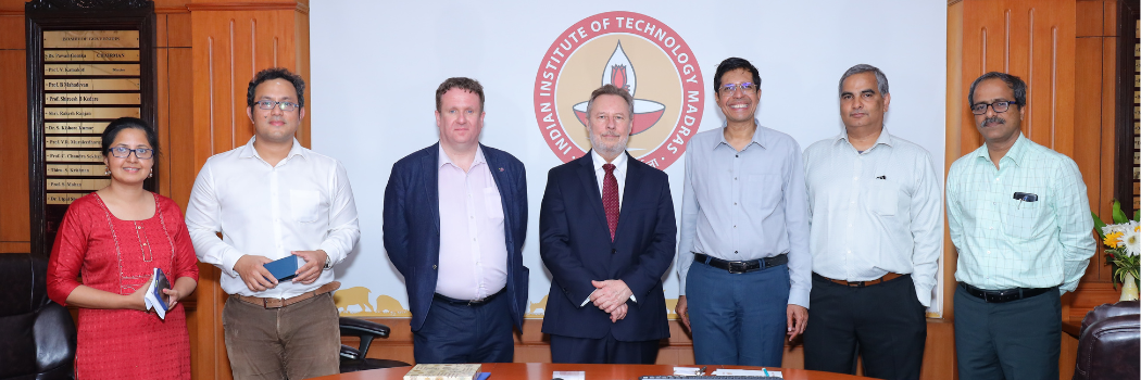 A group of people standing in front of a sign that says Indian Institute of Technology Madras