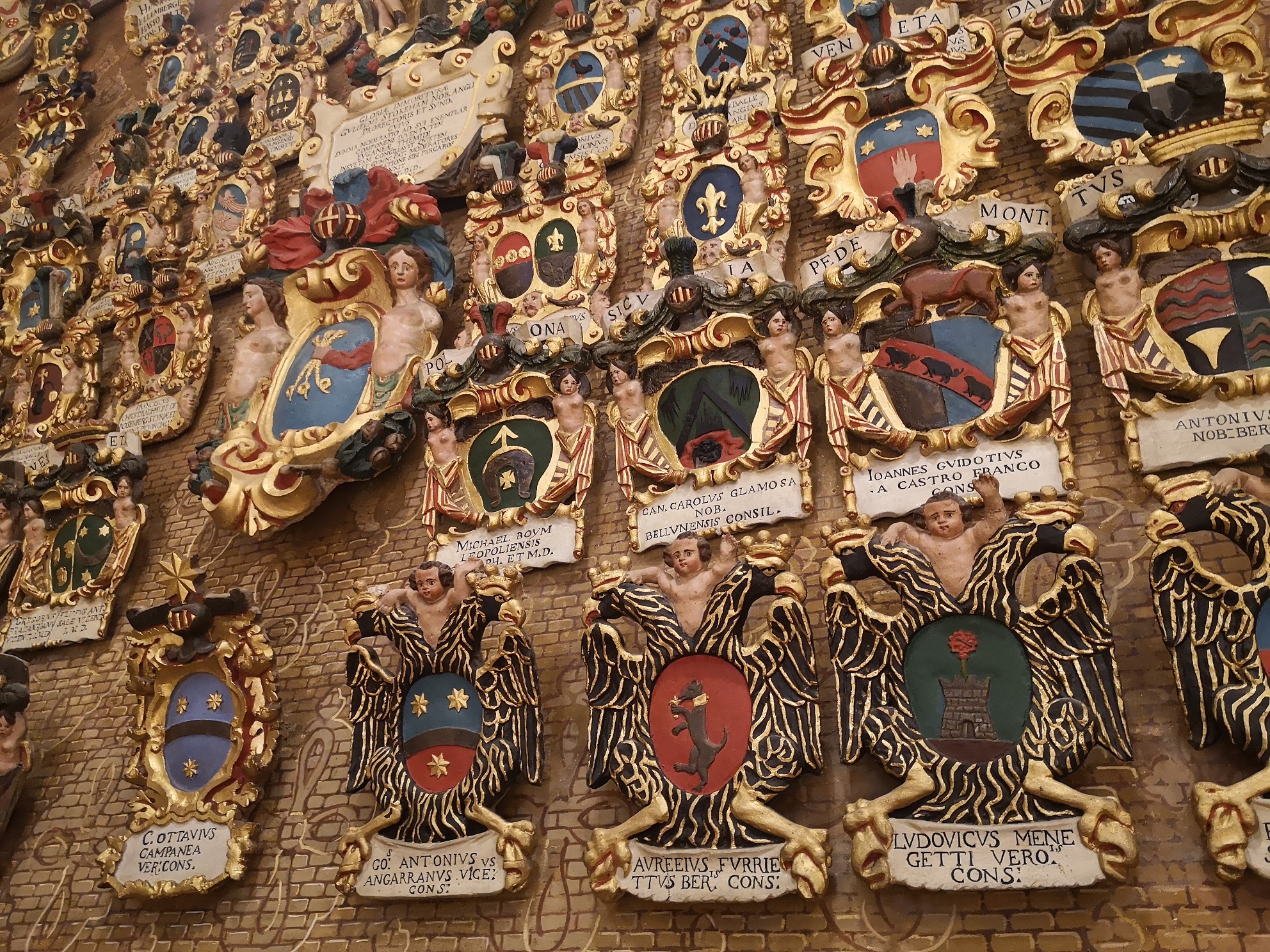 Shields and crests hung in a Padua University lecture theatre