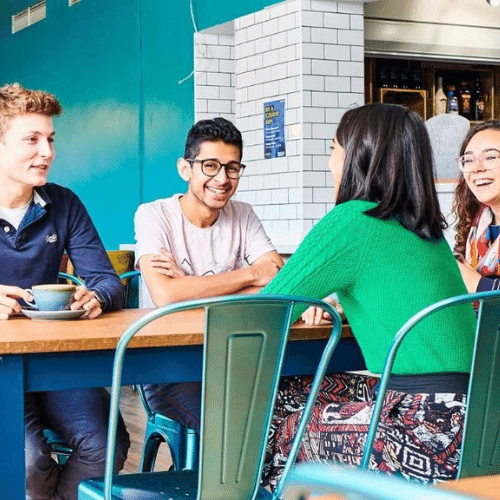 Four students sat around a coffee table