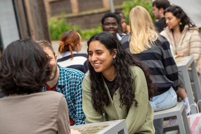 Students sitting outside palatine on benches