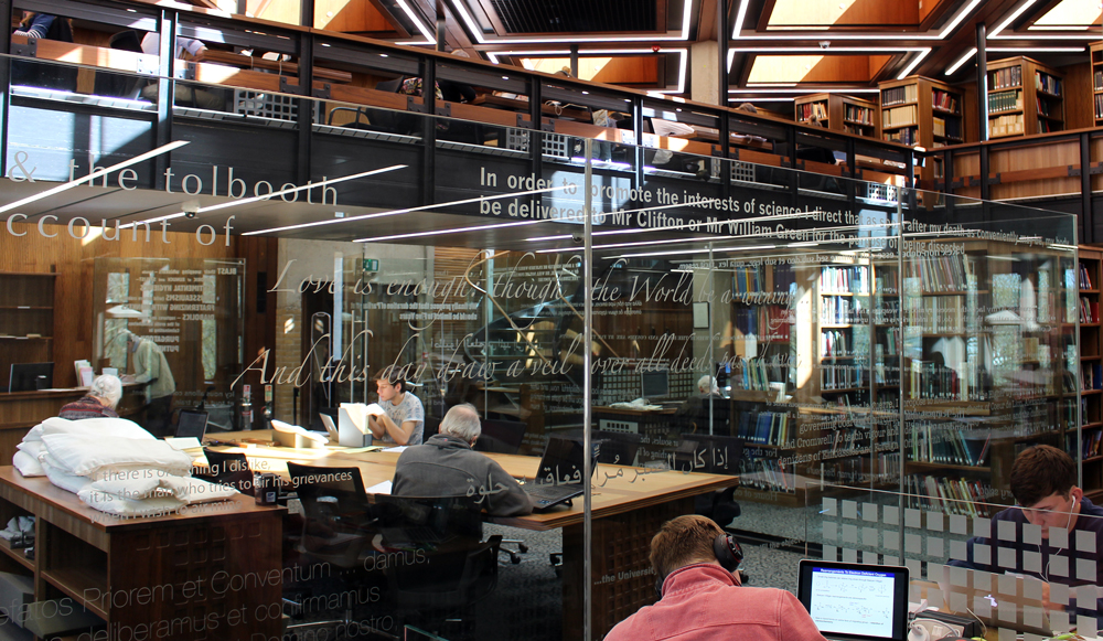 Students and researchers working with archives and special collections in the Search Room in the Barker Research Library at Palace Green Library