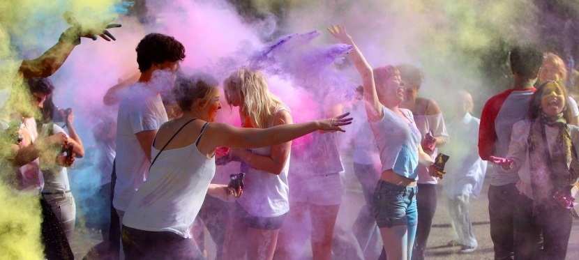 People throwing coloured powder while celebrating Holi festival