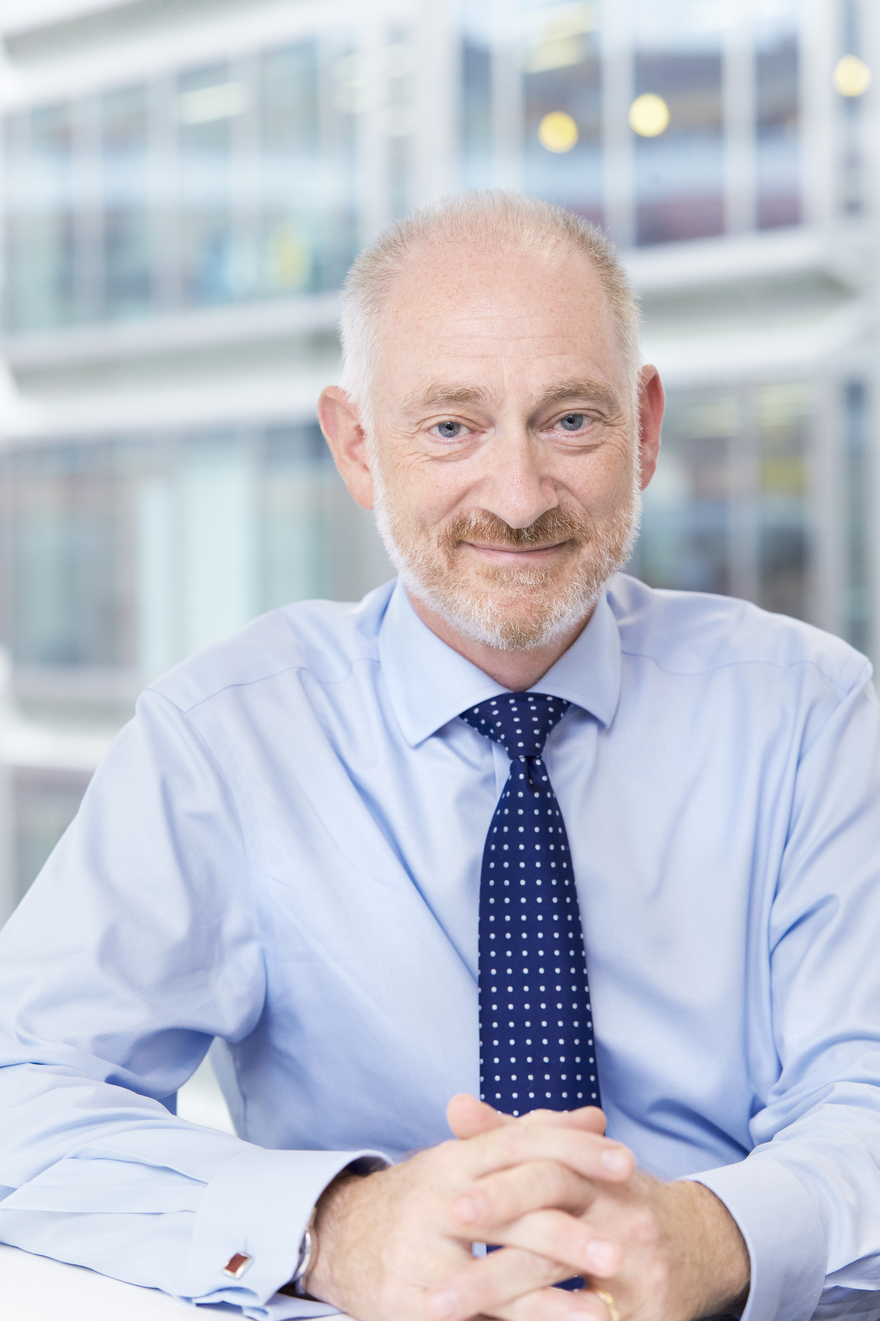 man in ties sat at office desk