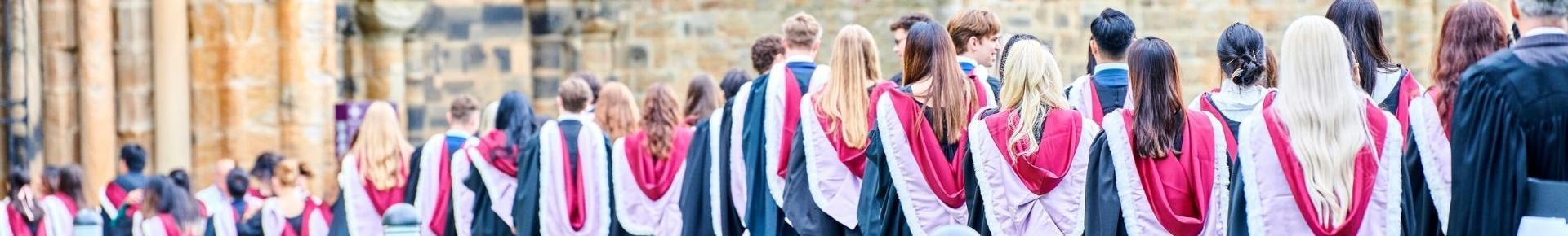 Graduands in robes and hoods processing into Durham Cathedral