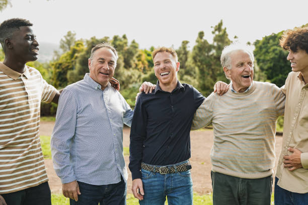 a group of men standing together smiling