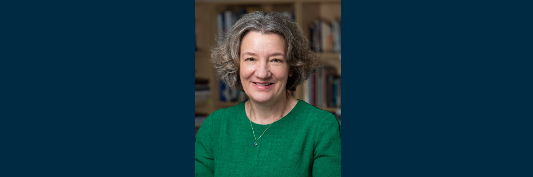 Our Vice-Chancellor Karen O'Brien with a background of books