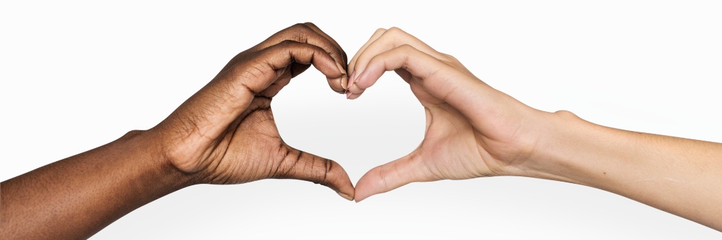 Two hands making a love heart sign