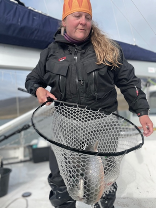 Woman with with migratory Arctic charr