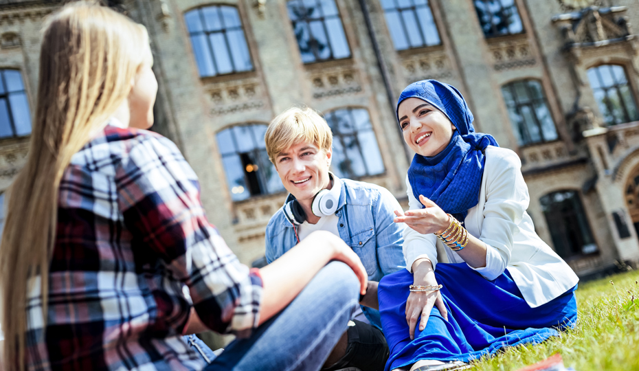 TStudents relaxing in the sun on Palace Green