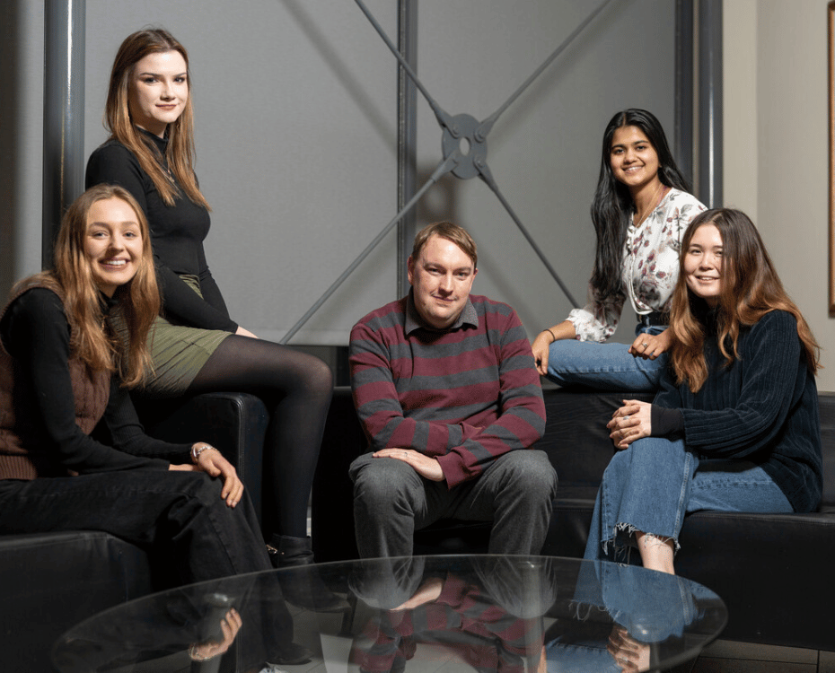 A mixed group of students sat down facing the camera