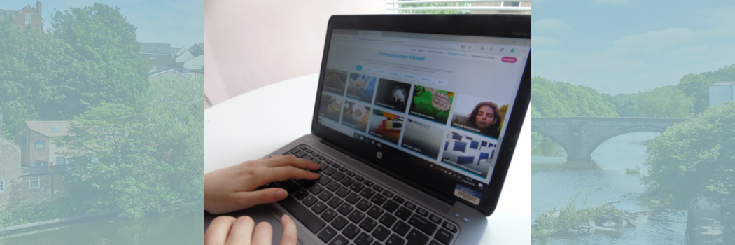 Laptop displaying hearing the voice website with cathedral background underlay