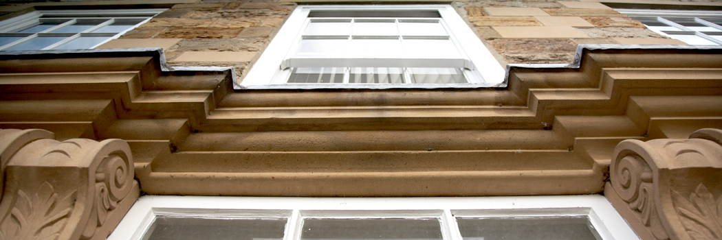 Looking up at the windows of Abbey House on Palace Green, Durham