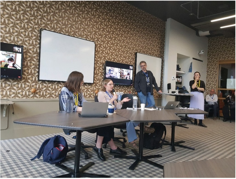 Female student sat at a table with other researchers