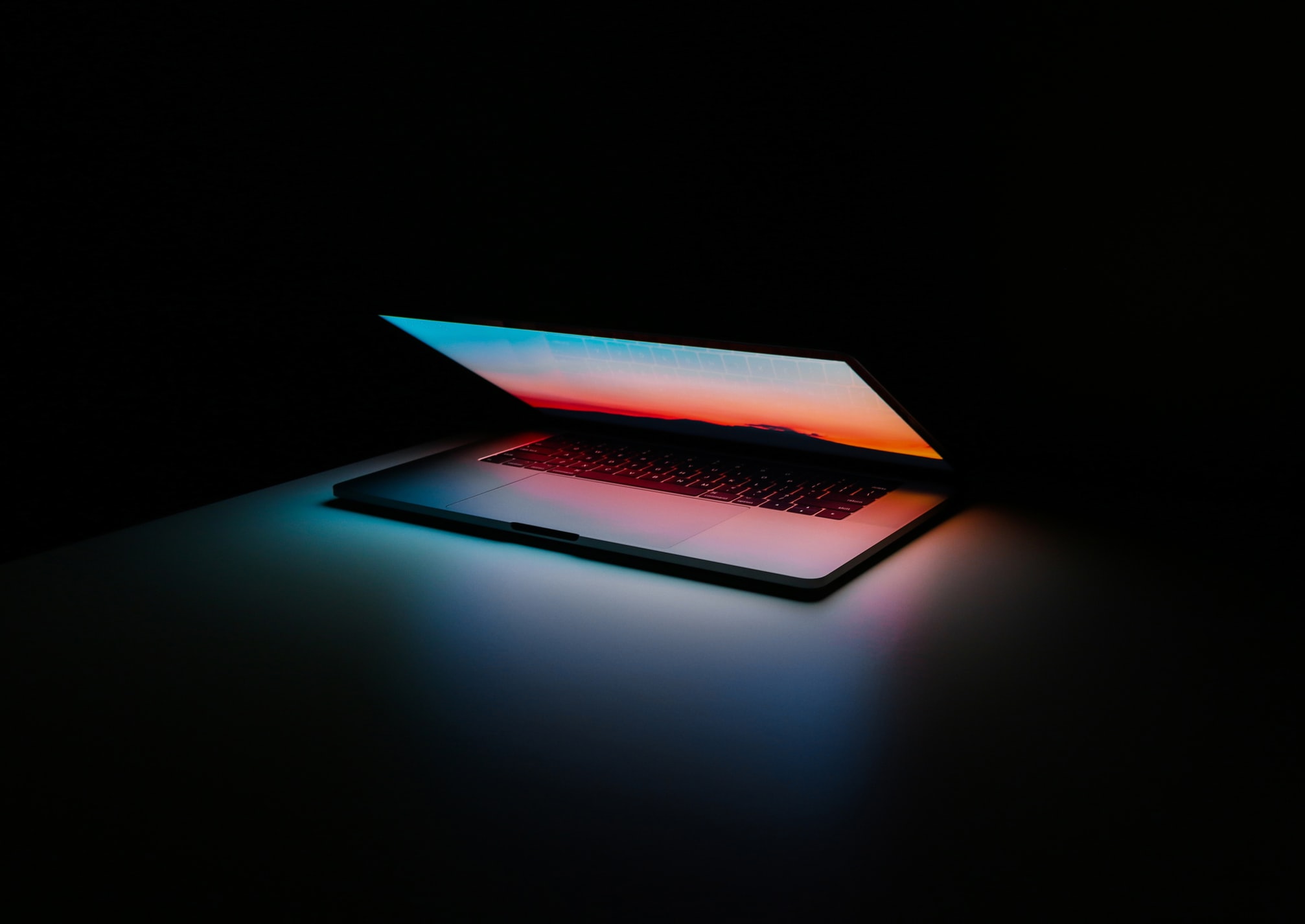 Glowing laptop in dark room