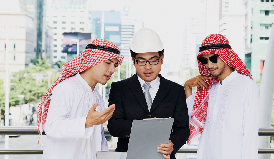 People examining a clipboard on a construction site