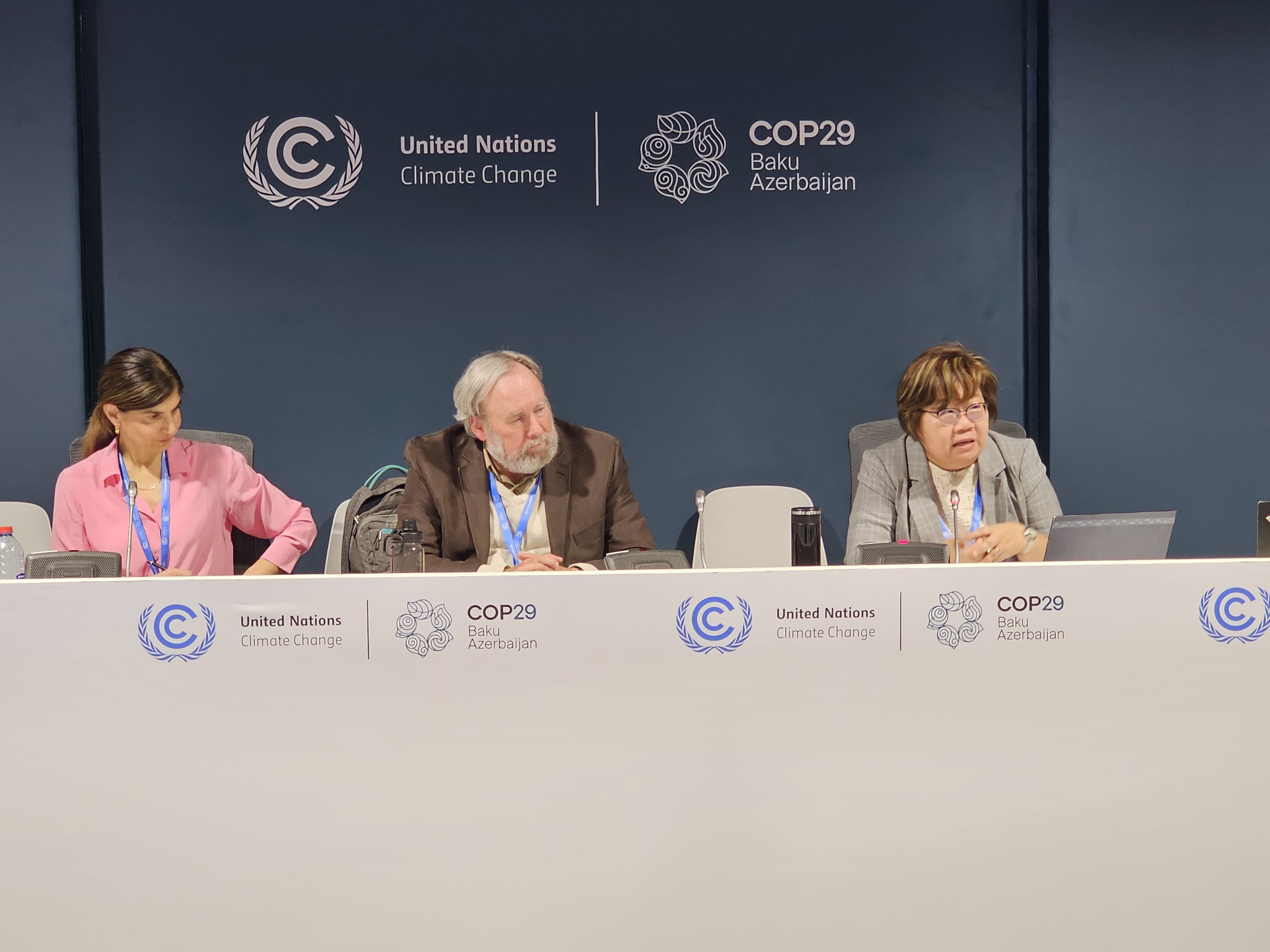 people sitting at the stage as panellists for the UNFCCC Side Event