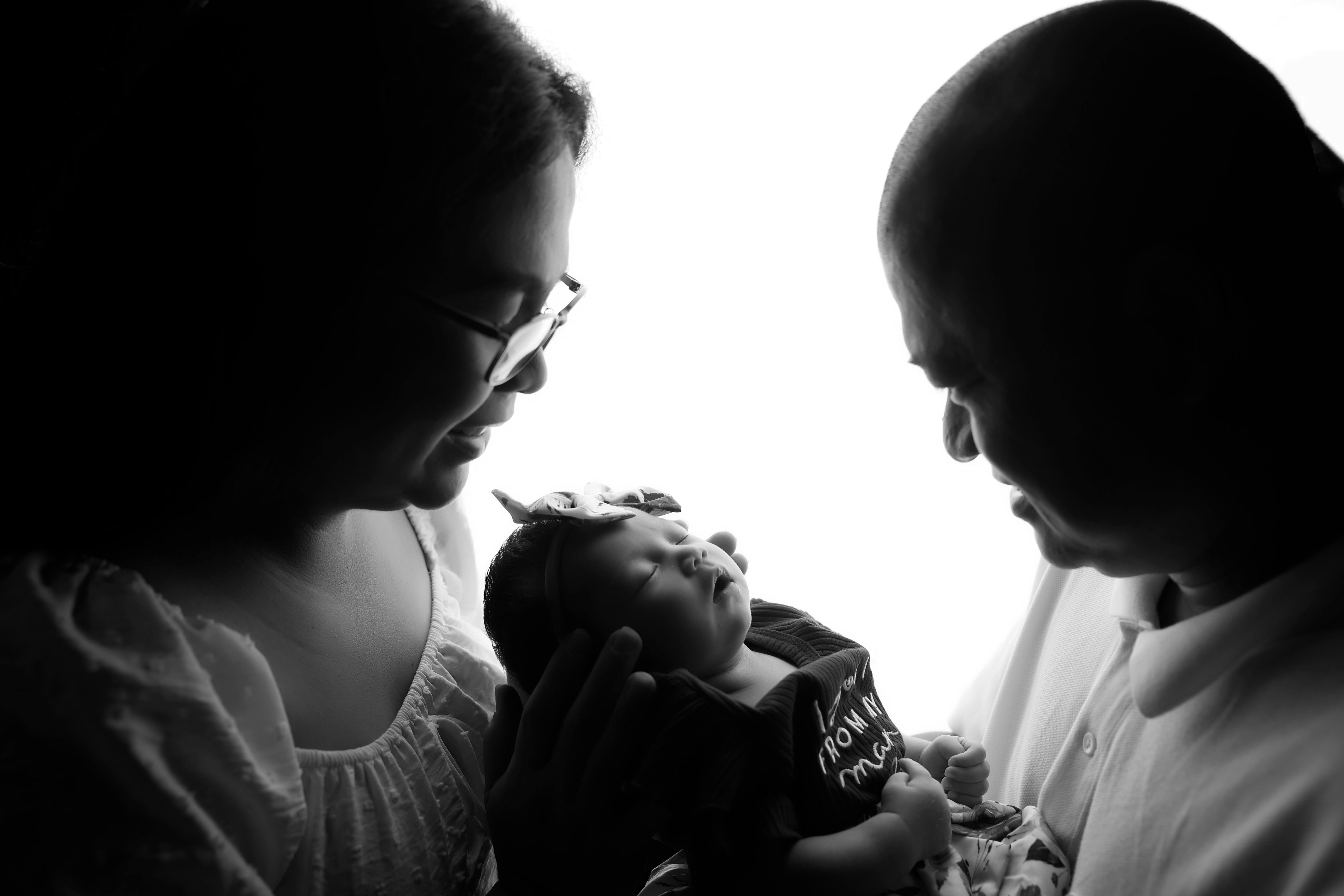 Two indigenous parents holding a new born infant