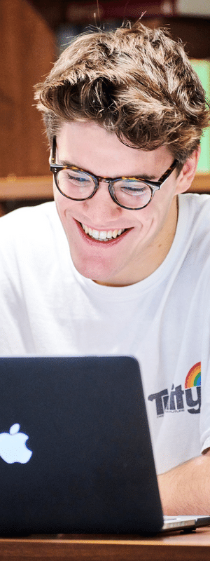 A student sitting at a laptop