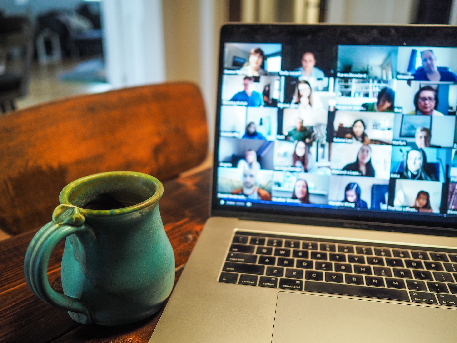 A mug with a laptop showing a Zoom call with many participants