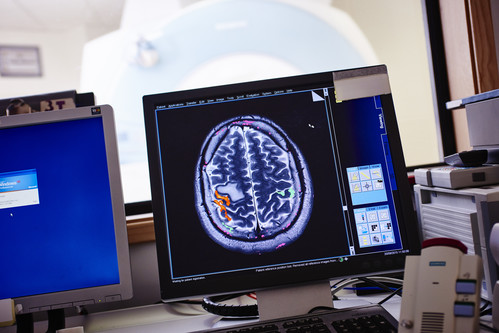 A computer monitor displaying brain data in fMRI control room.